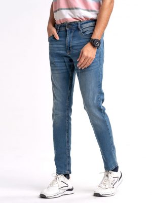 Men's slim fitted jeans in cotton spandex denim fabric. Four pockets, button fastening on the front and zipper fly.